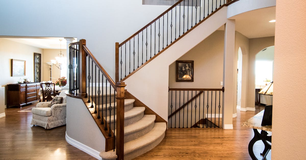 Spacious modern interior showcasing a stylish wooden staircase and elegant decor.